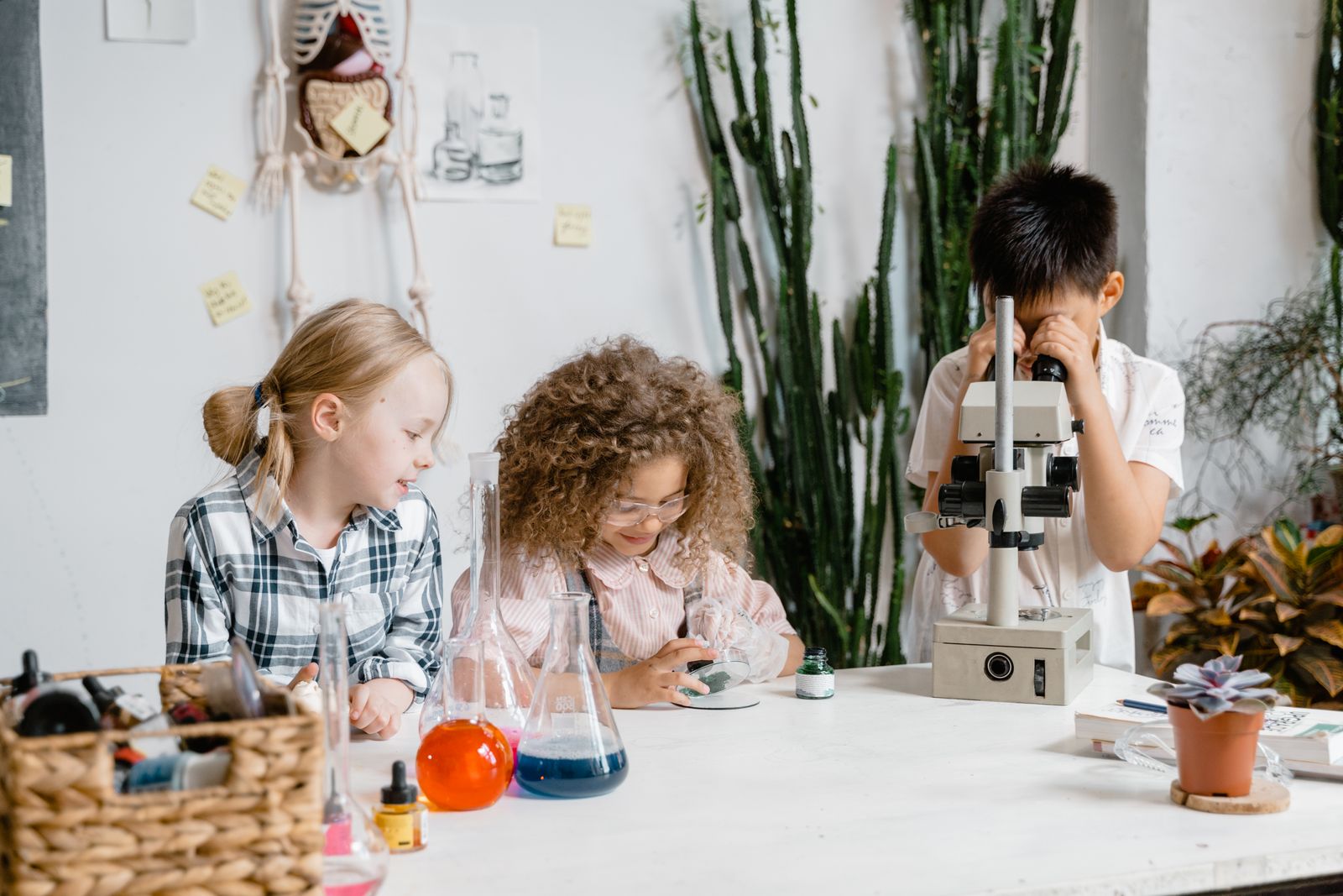 Children carrying out hands-on science experiments with lab equipment.